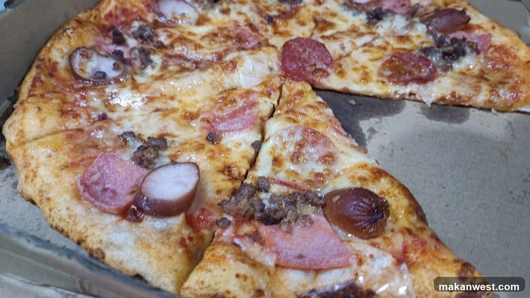 Pepperoni and sausage pizza slice