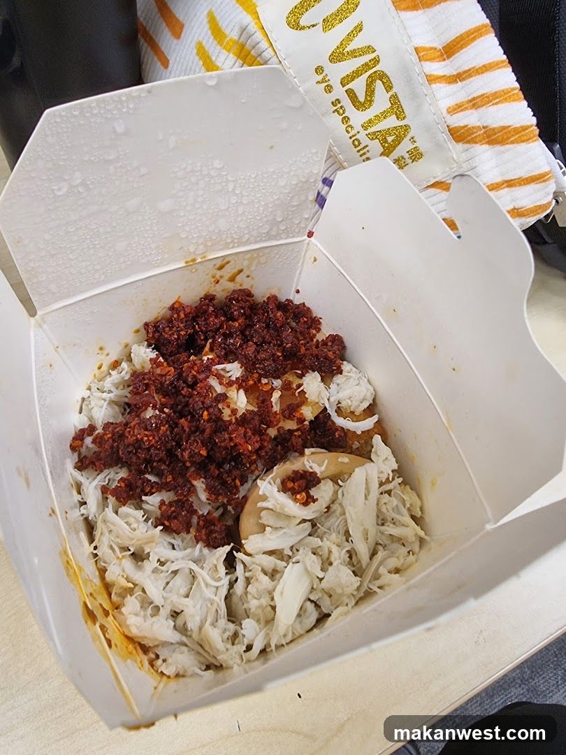 Takeout food container with shredded chicken and chili paste
