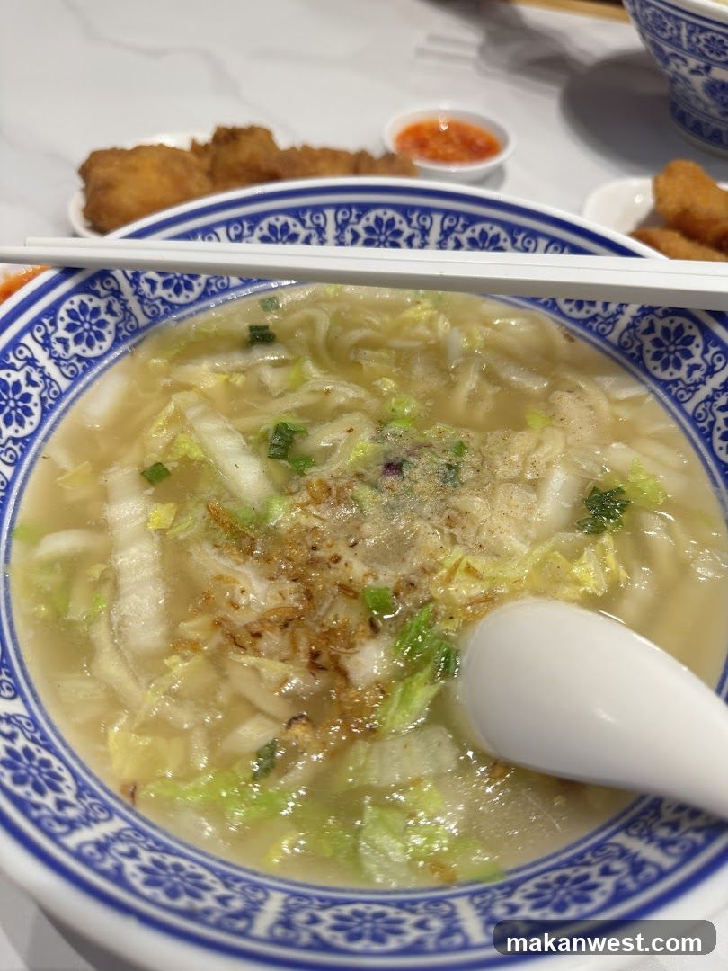 Bowl of Noodle Soup with Chopsticks and Spoon