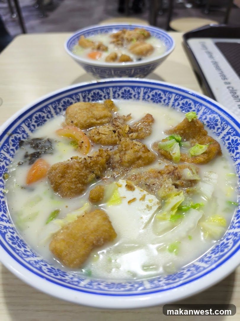 Bowl of Soup with Fried Dough and Vegetables