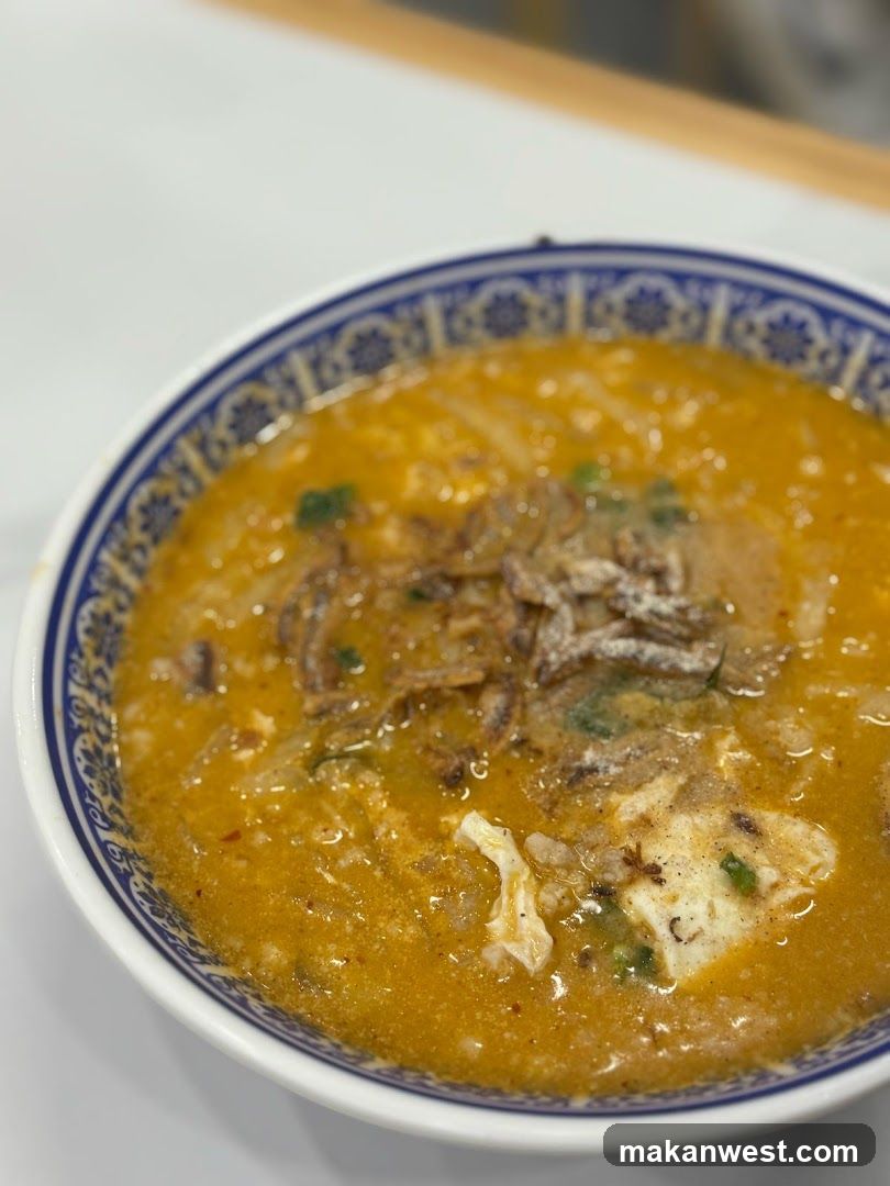 Bowl of Curry Soup with Tofu and Crispy Onions