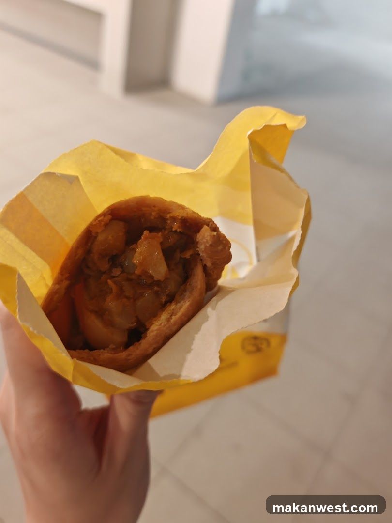 Handheld food item in yellow paper