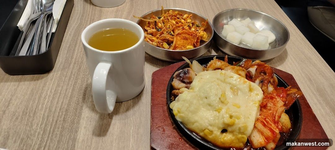 Korean-style meal with side dishes and tea