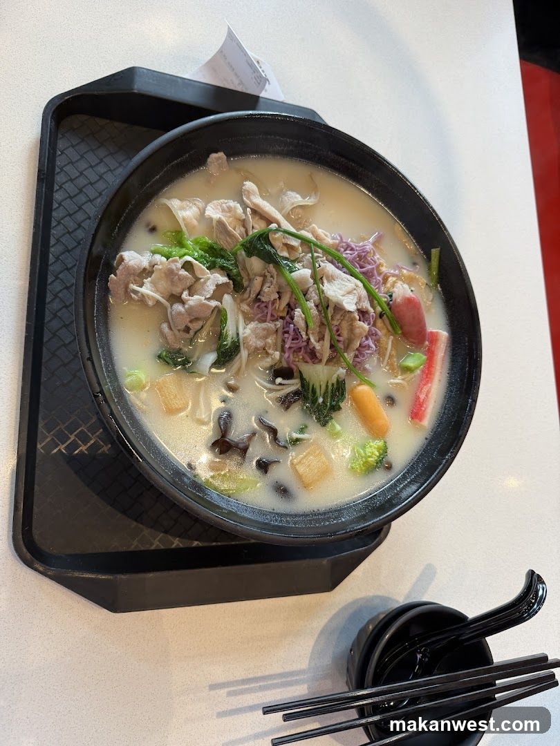 Bowl of Creamy Soup with Meat and Vegetables