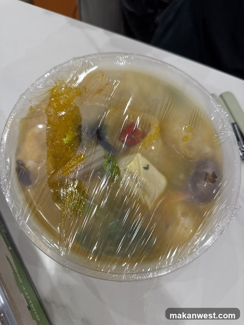 Takeout Bowl of Soup with Plastic Wrap
