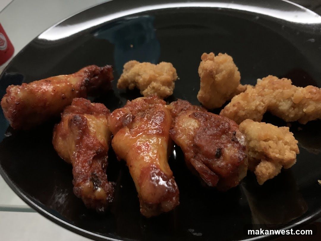 Fried Chicken Wings and Nuggets on Black Plate