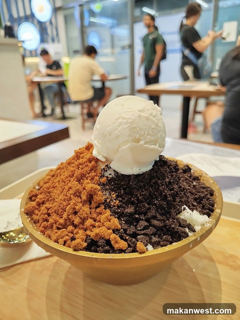 Bowl of shaved ice dessert with toppings and scoop of ice cream