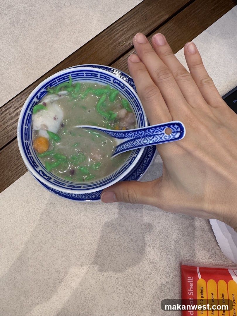 Bowl of Green Soup with Hand