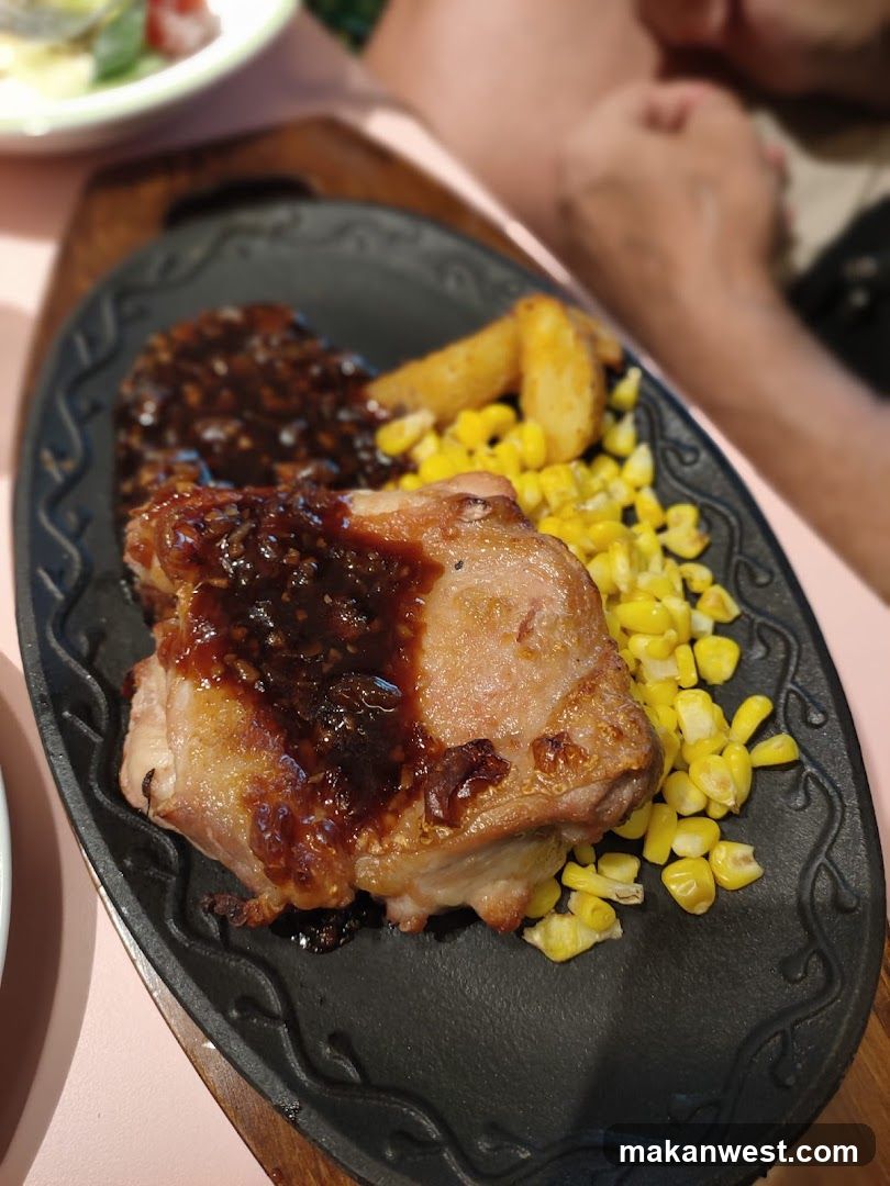 Sizzling Chicken Dish with Corn and Fries