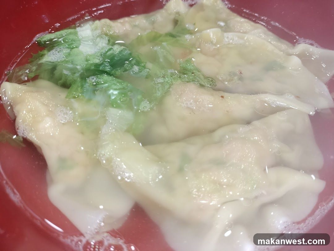 Dumplings in Soup with Lettuce Garnish