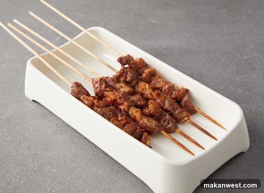 Grilled Meat Skewers on a White Rectangular Plate
