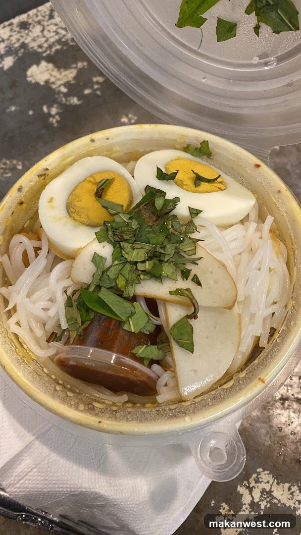 Bowl of Noodle Soup with Egg and Herbs