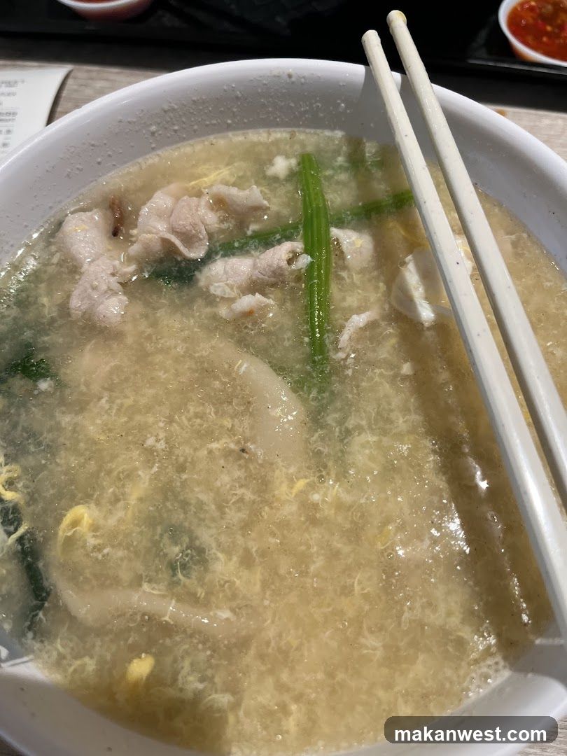 Bowl of Soup with Chopsticks