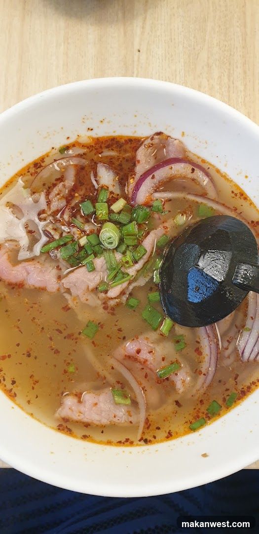 Bowl of Spicy Soup with Meat and Onions