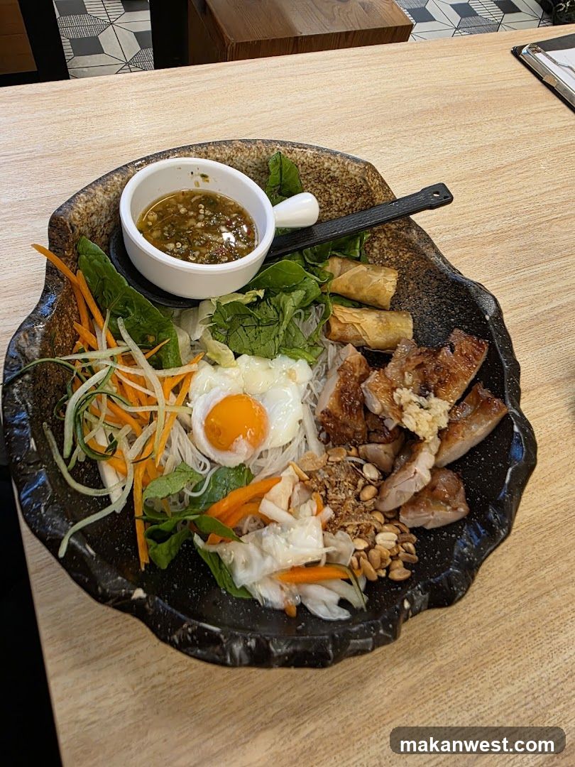 Bowl of Vietnamese-style noodle dish with egg and pork