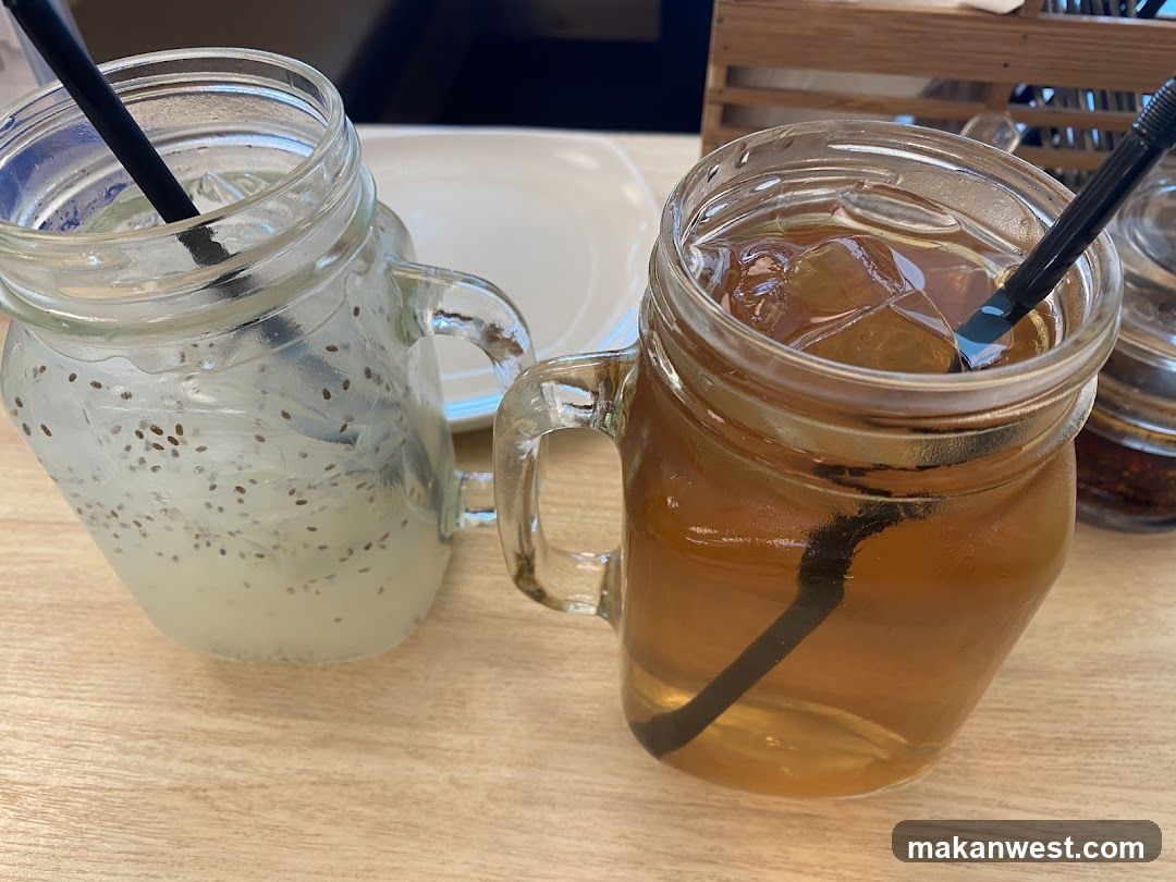 Two mason jar drinks on a table