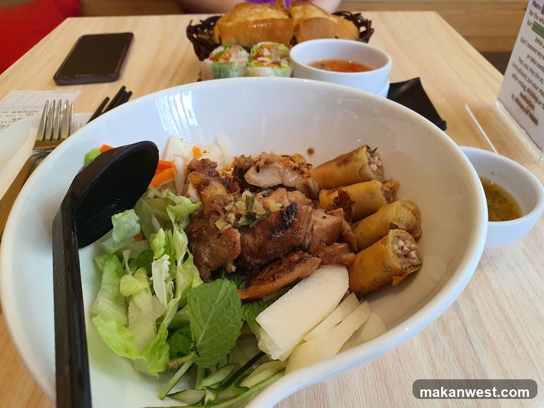 Vietnamese-style bowl with spring rolls and grilled meat