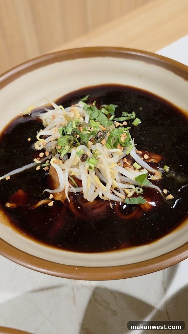 Dish with dark sauce and garnishes