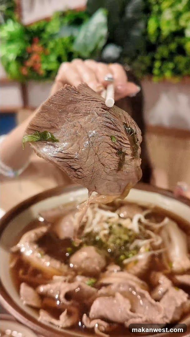 Hand Holding Slice of Meat Over Bowl