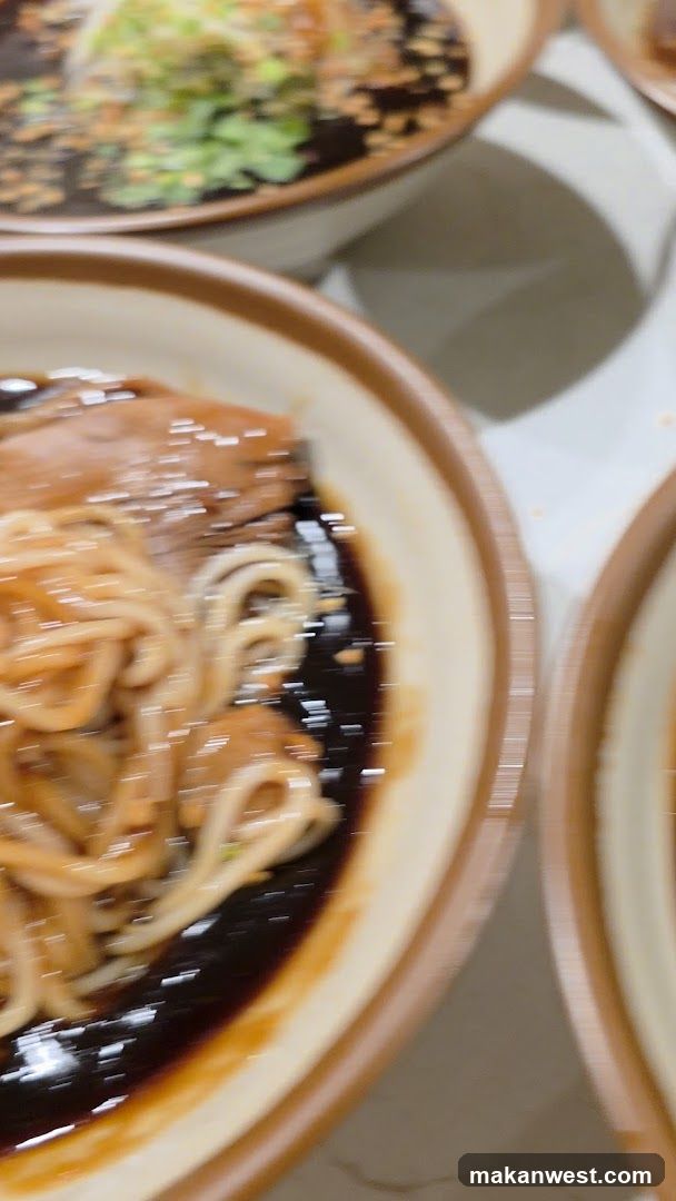 Bowl of noodles with sauce and toppings