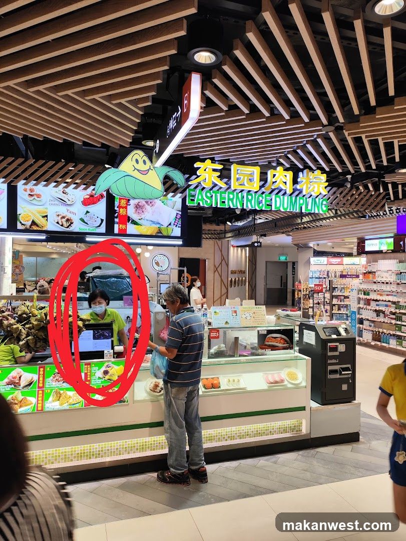 Food stall interior with staff and customer