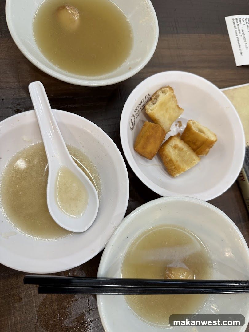 Dish with soup and fried dough sticks