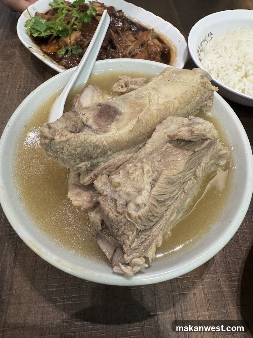 Bowl of Chicken Soup with Rice and Side Dishes