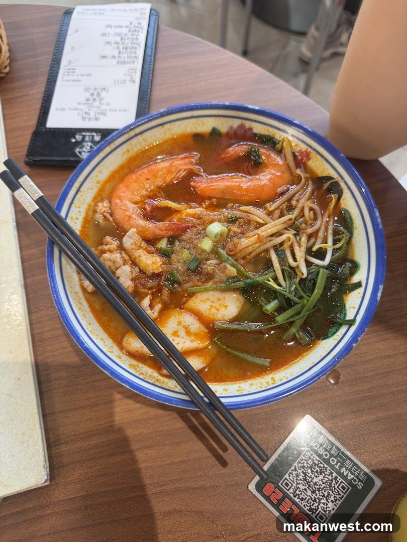 Bowl of spicy noodle soup with shrimp and vegetables