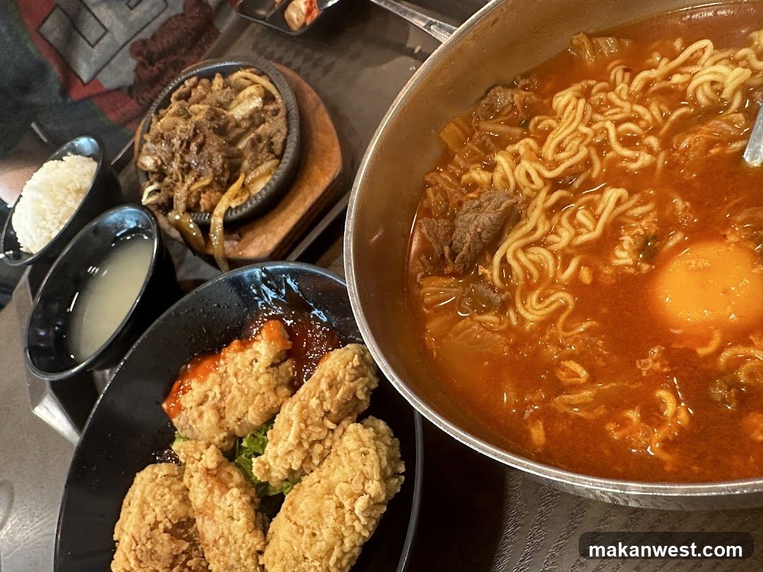 Korean-style meal with fried chicken and spicy noodles