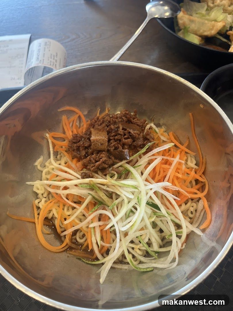 Bowl of Korean-style noodles with vegetables and meat sauce