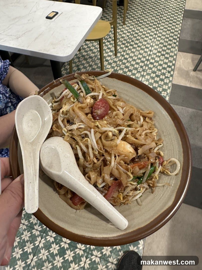Plate of stir-fried noodles with two spoons