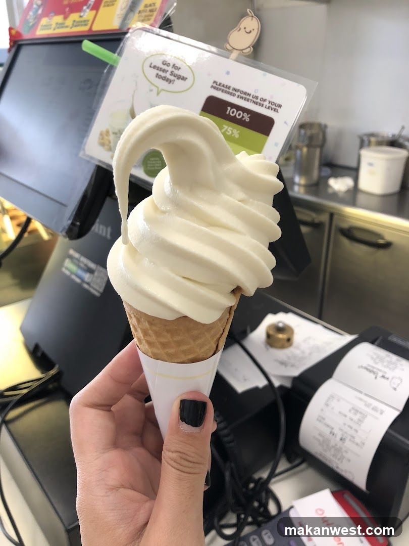 Soft-serve ice cream cone in a shop interior