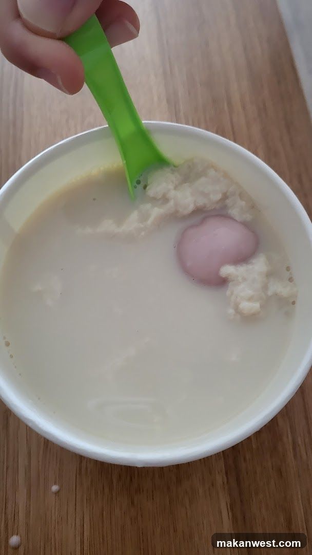 Bowl of congee with egg and rice balls