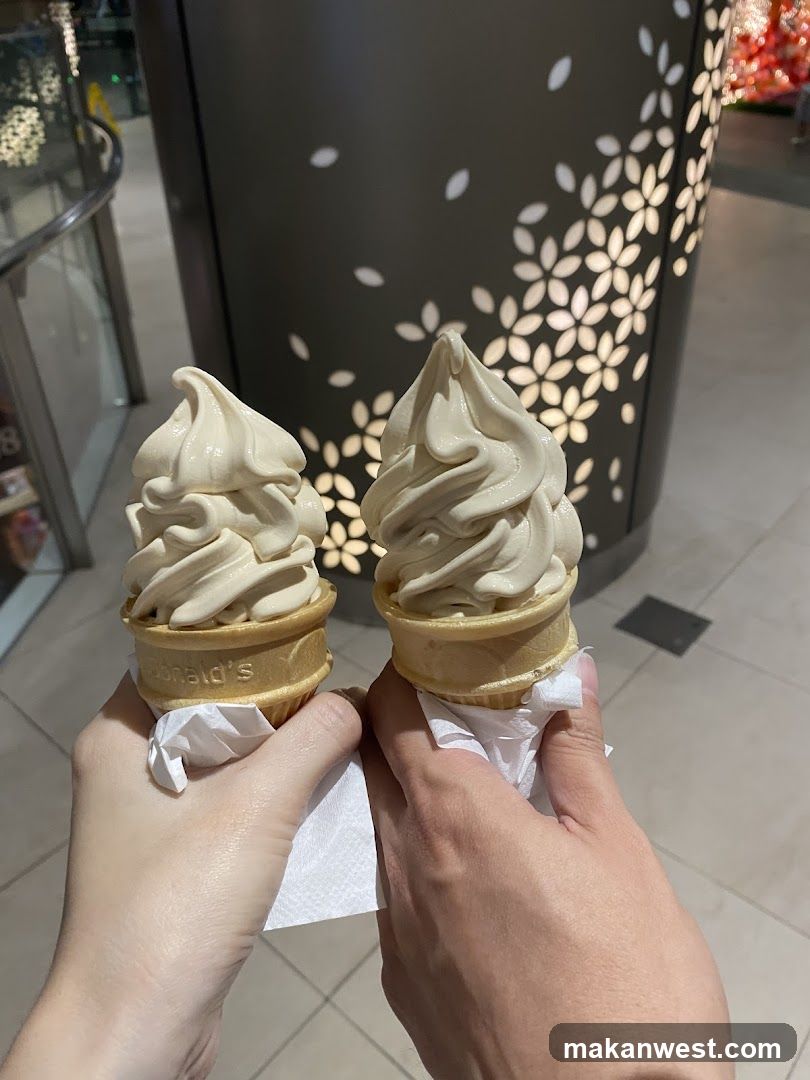 Two soft-serve ice cream cones held up