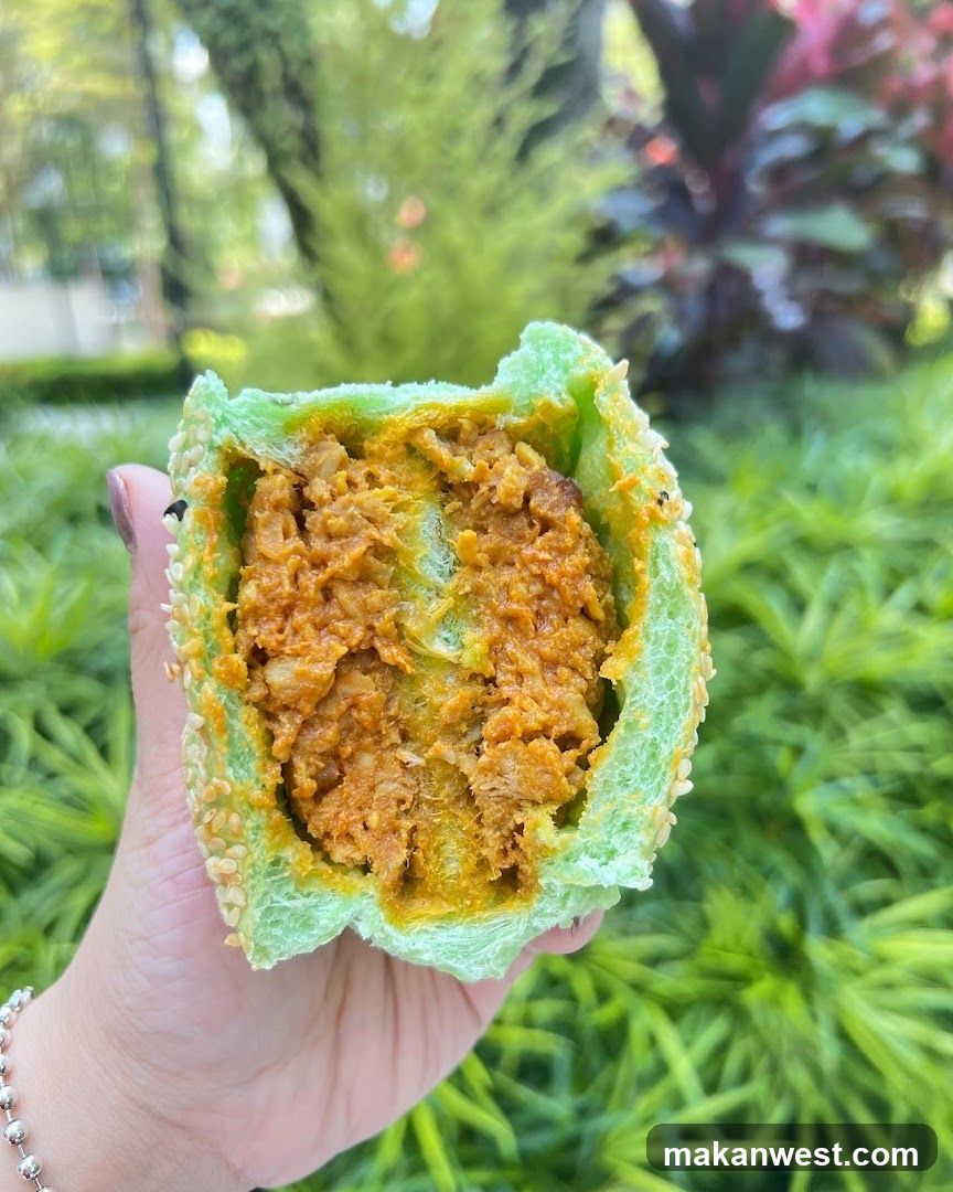 Green-wrapped food item with sesame seeds