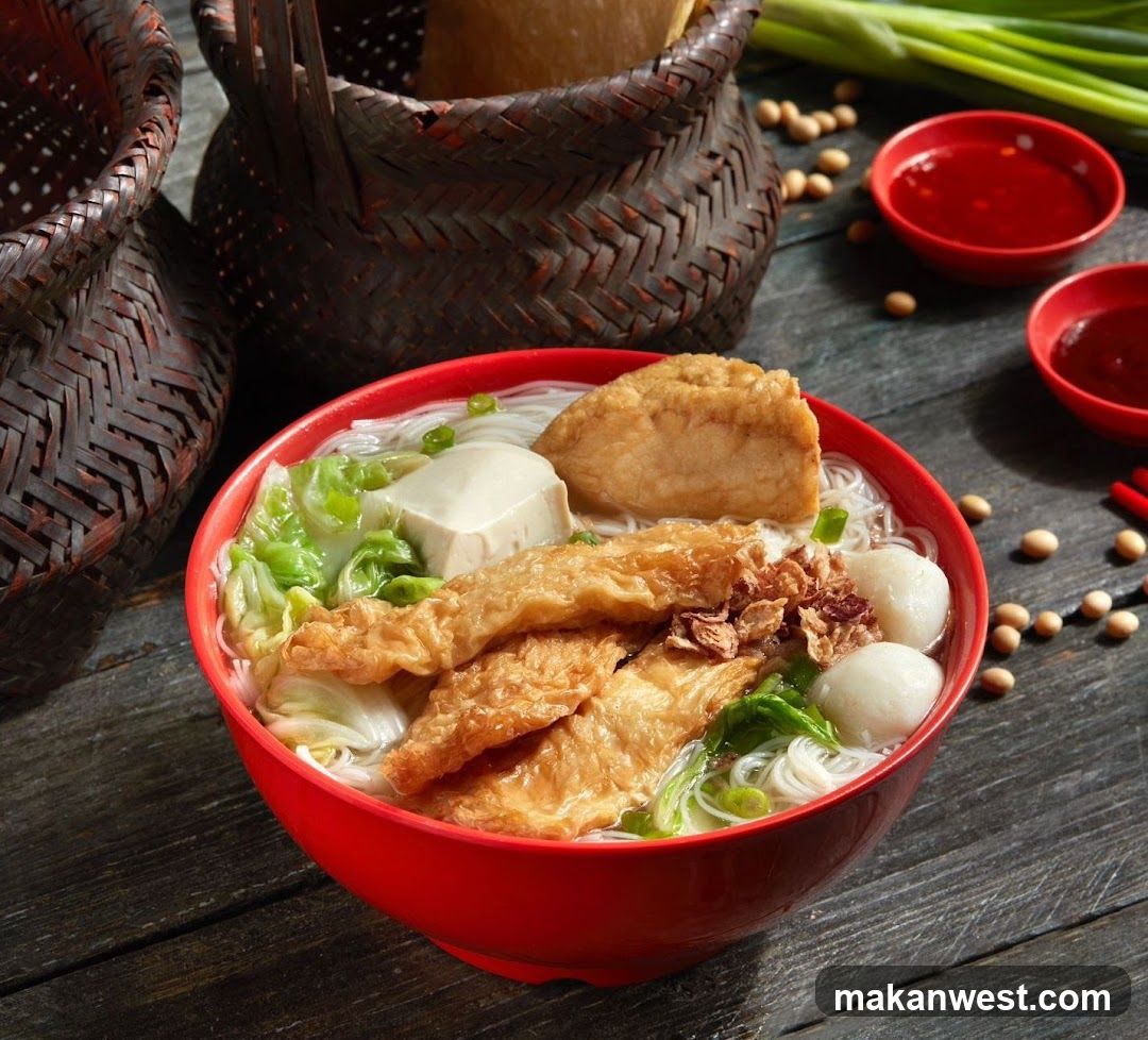 Red Bowl of Noodle Soup with Tofu and Fried Dishes