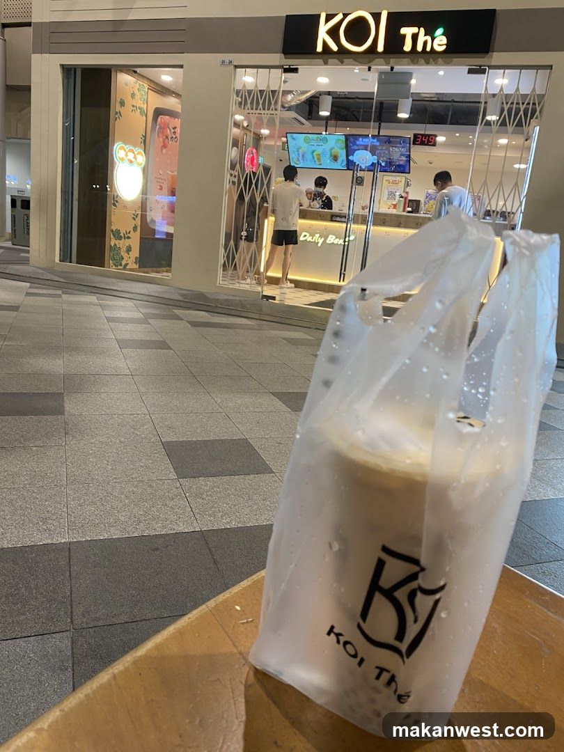 Koi The Coffee Shop Exterior with Drink in Foreground
