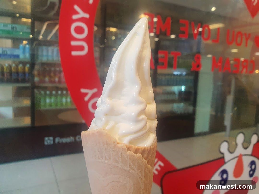 Soft-serve ice cream cone in front of a store window