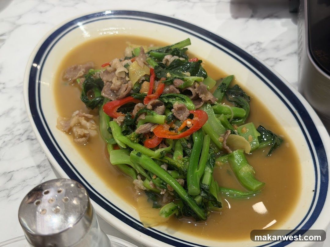 Stir-fried greens with beef and chili peppers in sauce
