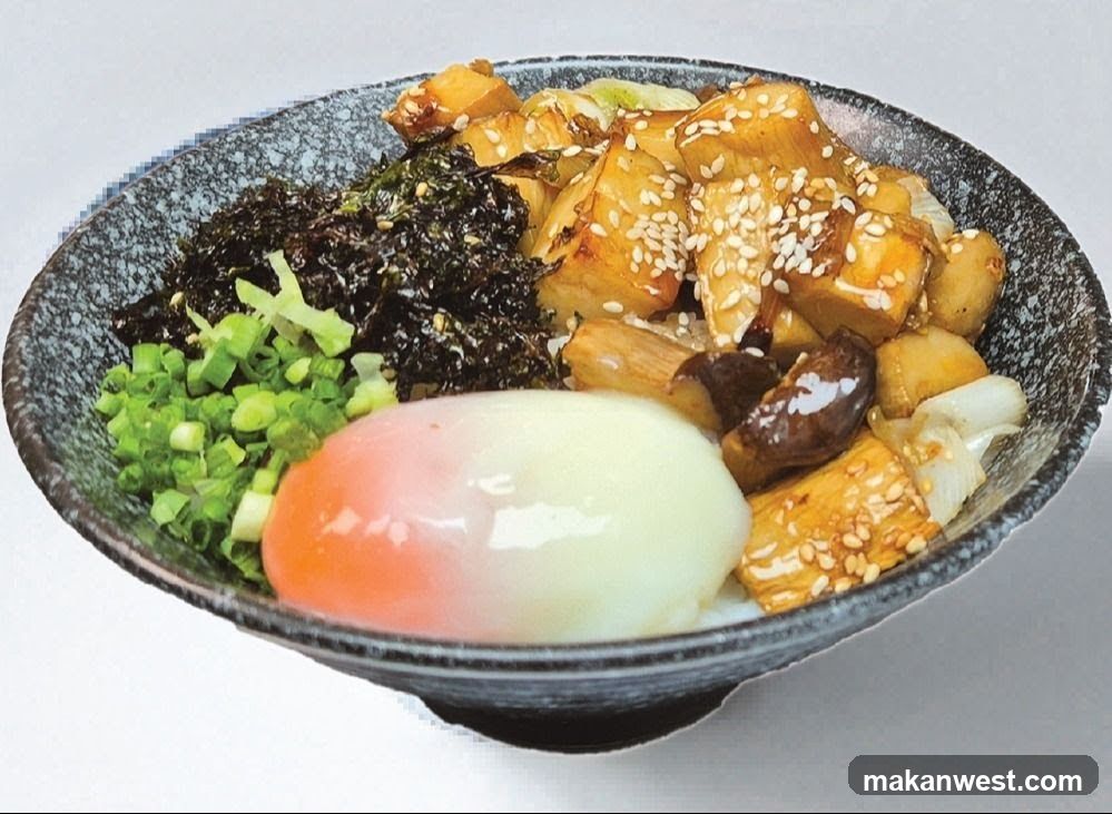 Bowl of Japanese-style rice dish with egg and vegetables