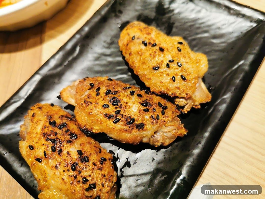 Sesame Chicken Wings on Black Plate