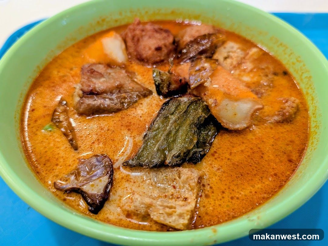 Bowl of Curry Soup with Meat and Vegetables