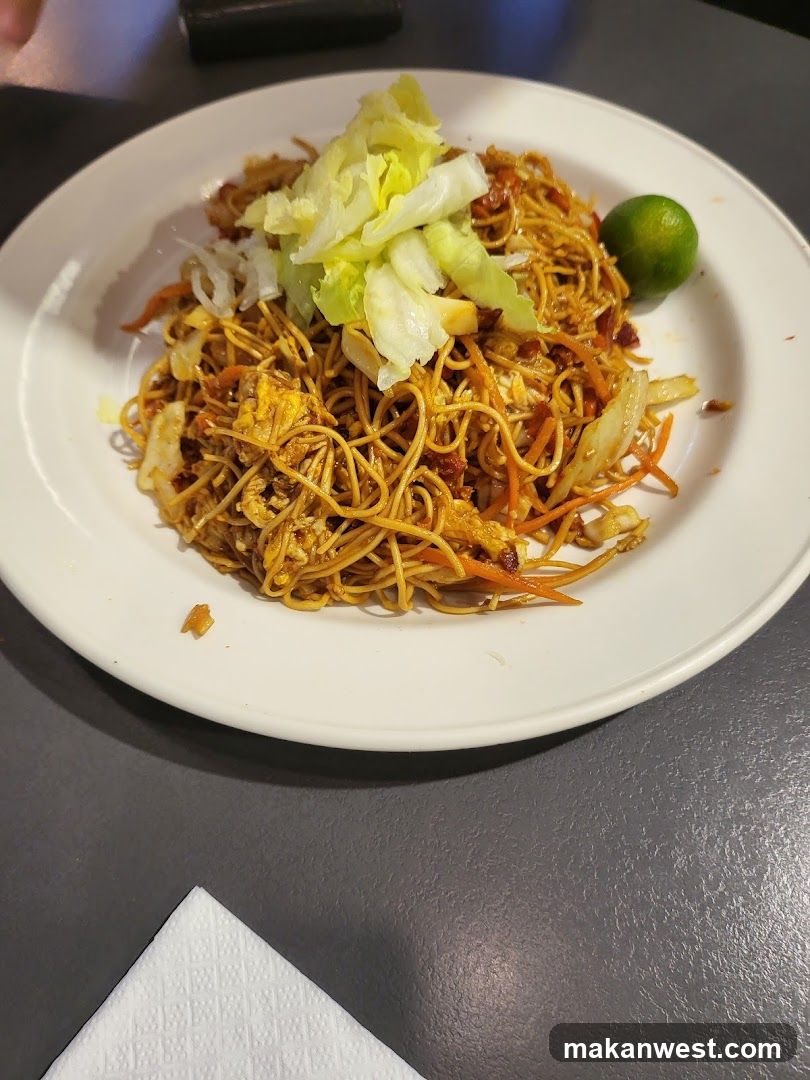 Plate of Stir-fried Noodles with Lettuce and Lime