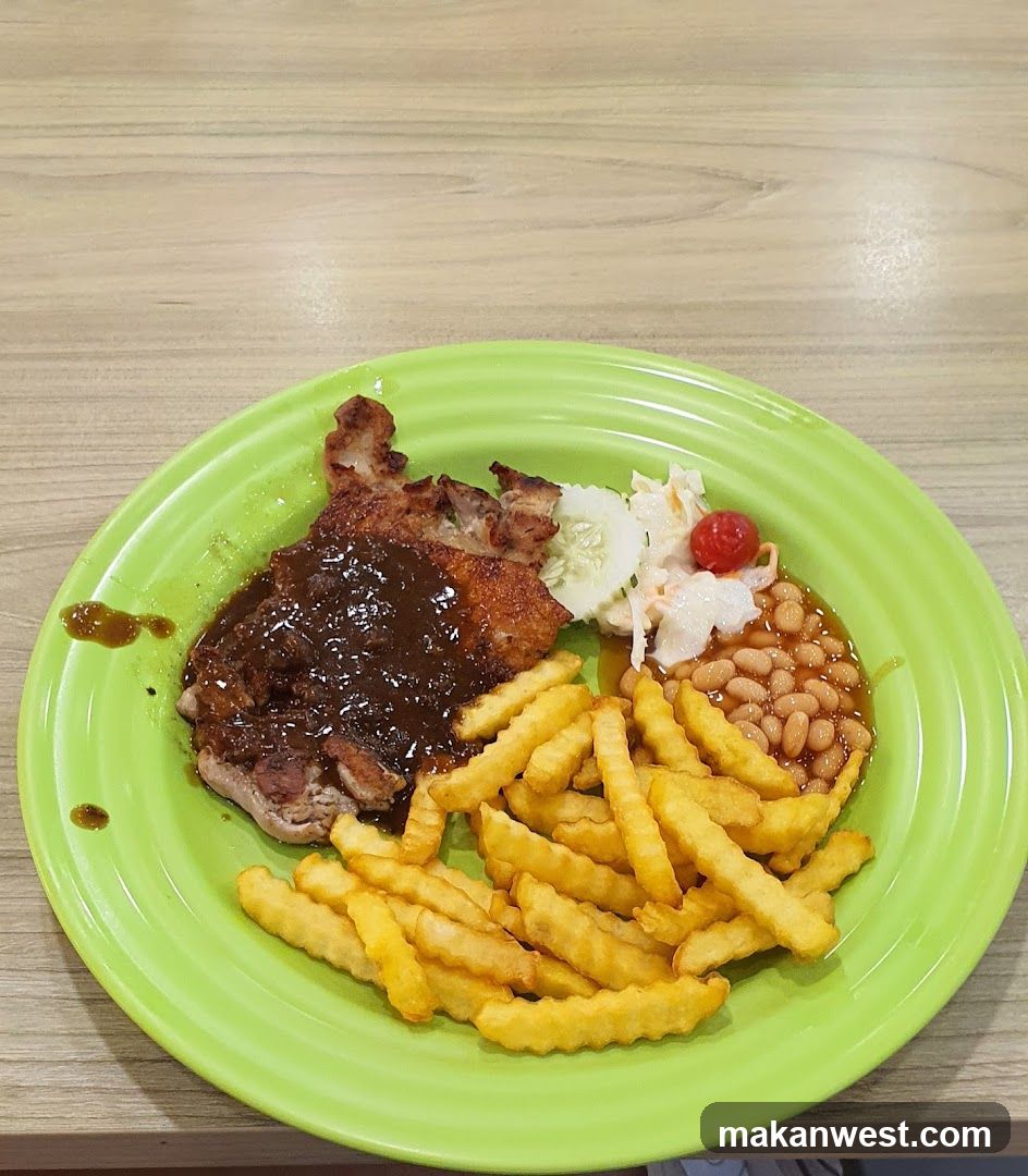 Plate of Crispy Pork Chop with Fries and Baked Beans