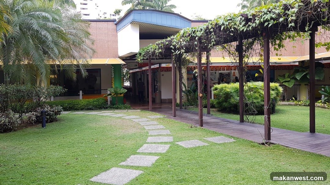 Lush Garden Entrance with Pergola and Building Facade