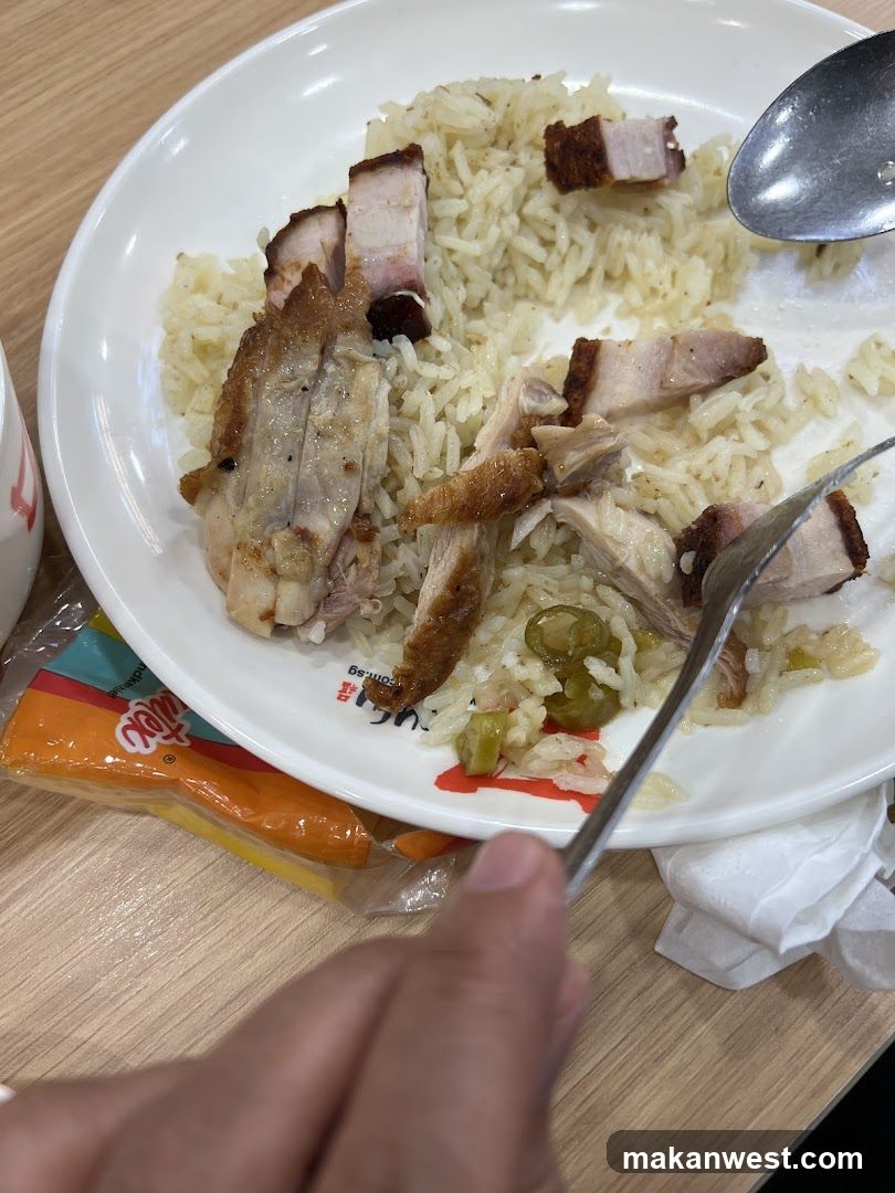 Plate of Chicken Rice with Chopsticks and Spoon