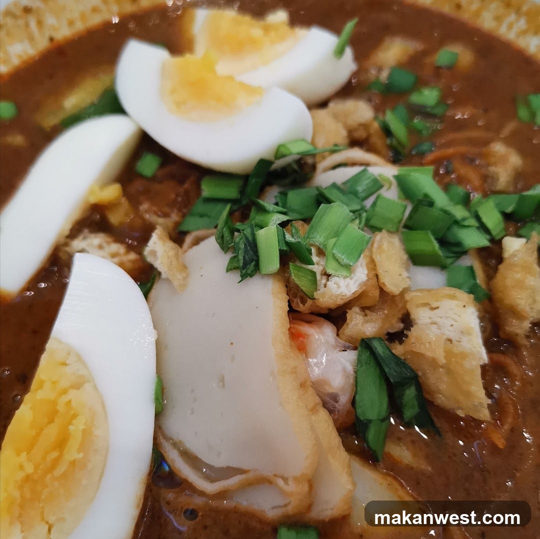 Curry Noodle Dish with Boiled Egg and Garnish