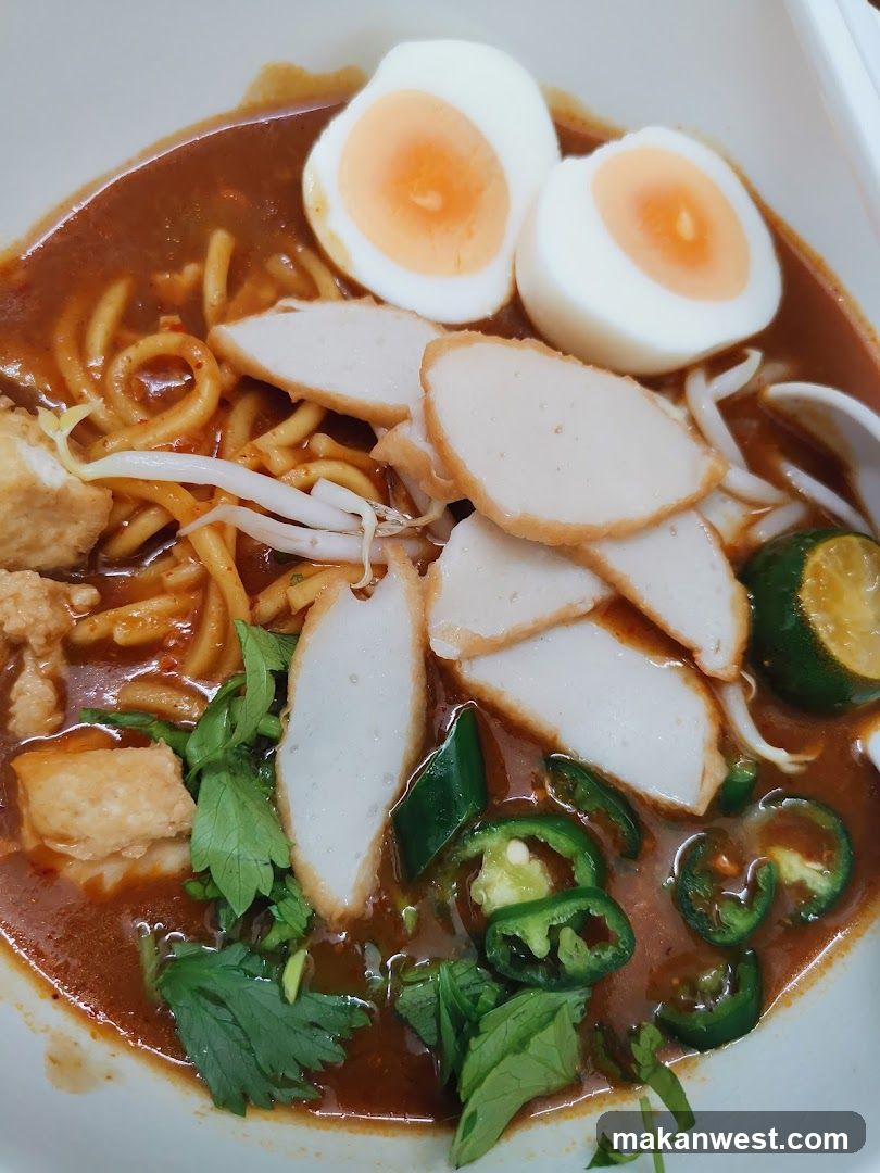 Spicy Noodle Bowl with Halved Egg and Sliced Meat