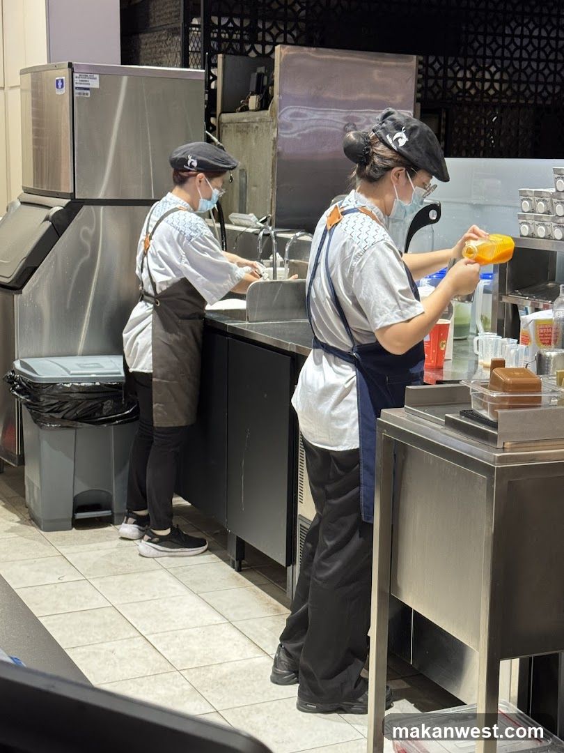 Staff Preparing Drinks in Kitchen