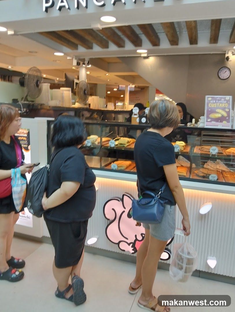 Customers at a bakery counter